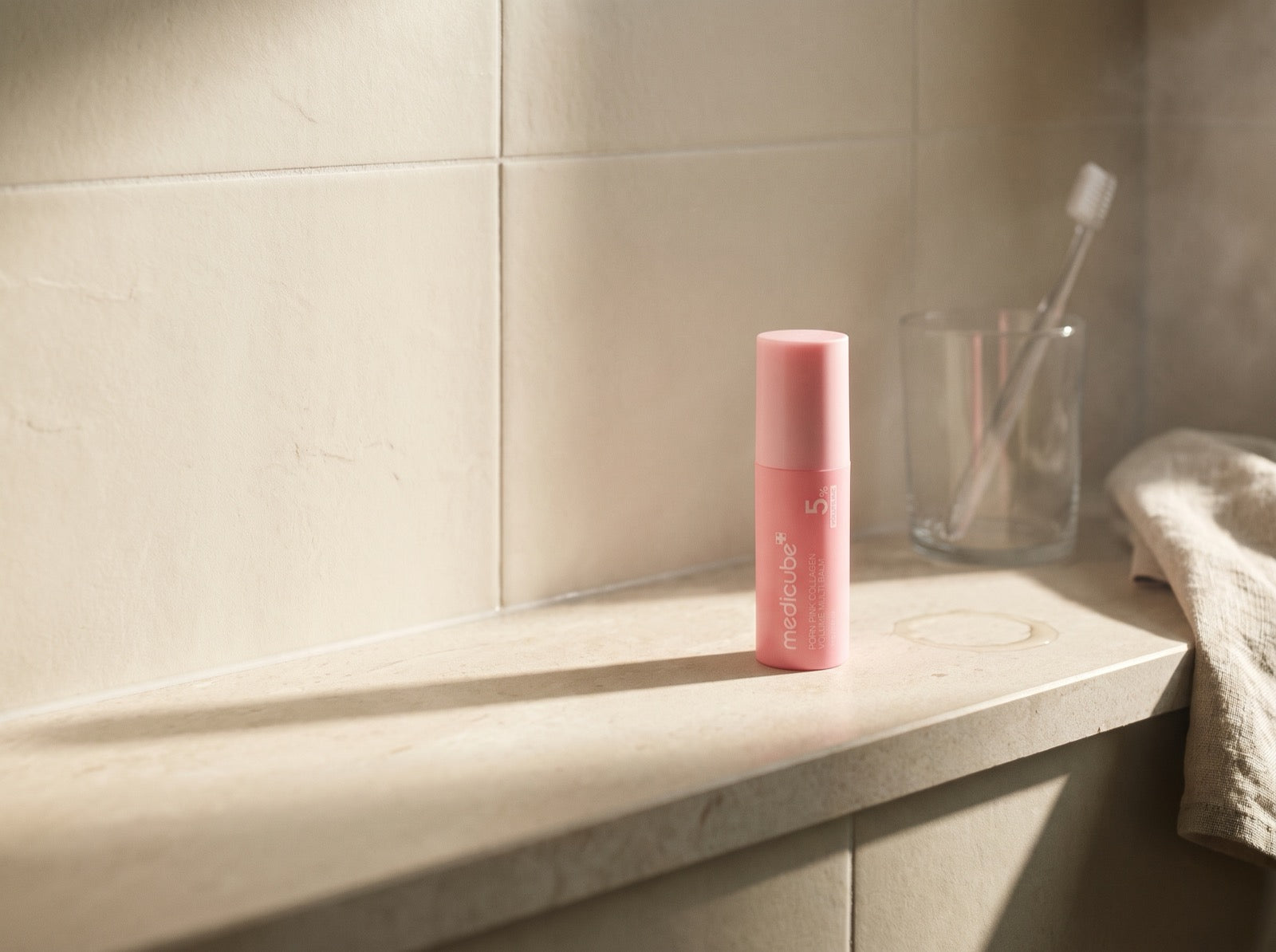 The stick on a sunlit bathroom shelf